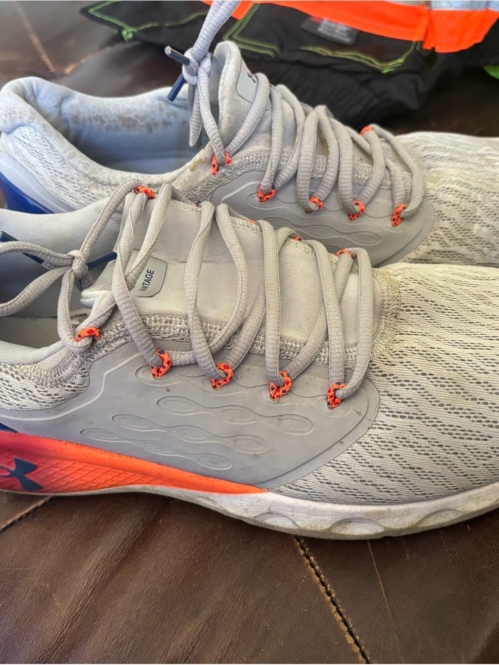 Under Armour Light Gray Running Shoes with Orange Accents